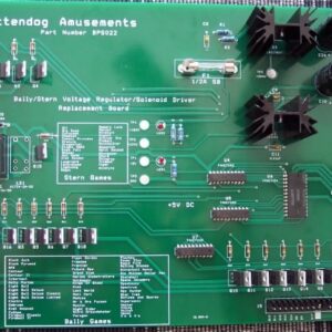 A green board with many different electronic components.