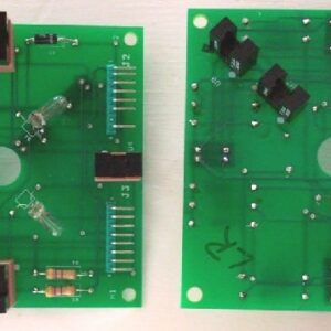 Two green boards with electronic components on top of them.