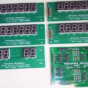 A set of six electronic displays on top of a green board.