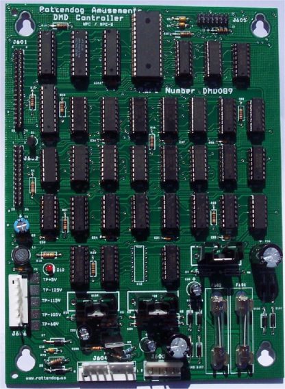 A green board with many different electronic components.