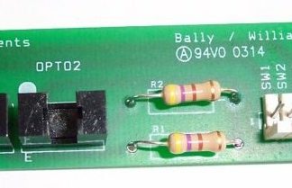 A green board with two yellow and white resistors.