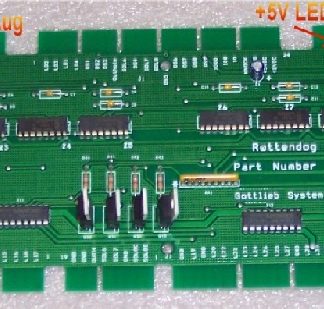 A green circuit board with many different types of electronic components.