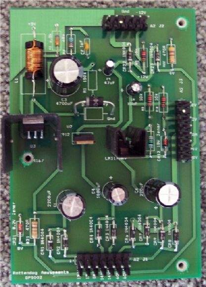 A green circuit board with many electronic components.