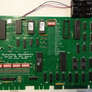 A green computer board with many different electronic components.