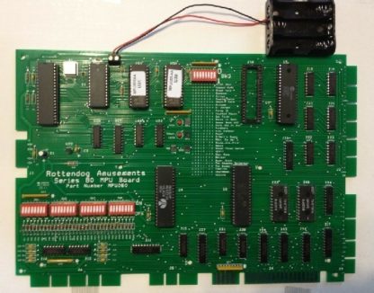 A green computer board with many different electronic components.