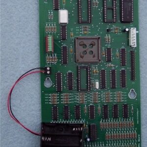 A green board with many different electronic components.