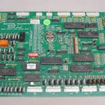 A green computer board with many different wires.