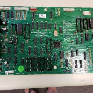 A green circuit board sitting on top of a table.