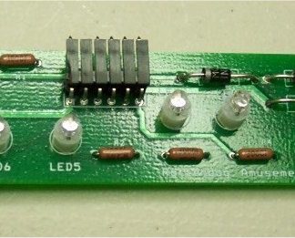 A green circuit board with many lights on it.