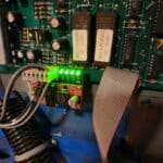 A green light is on the side of an electronic board.